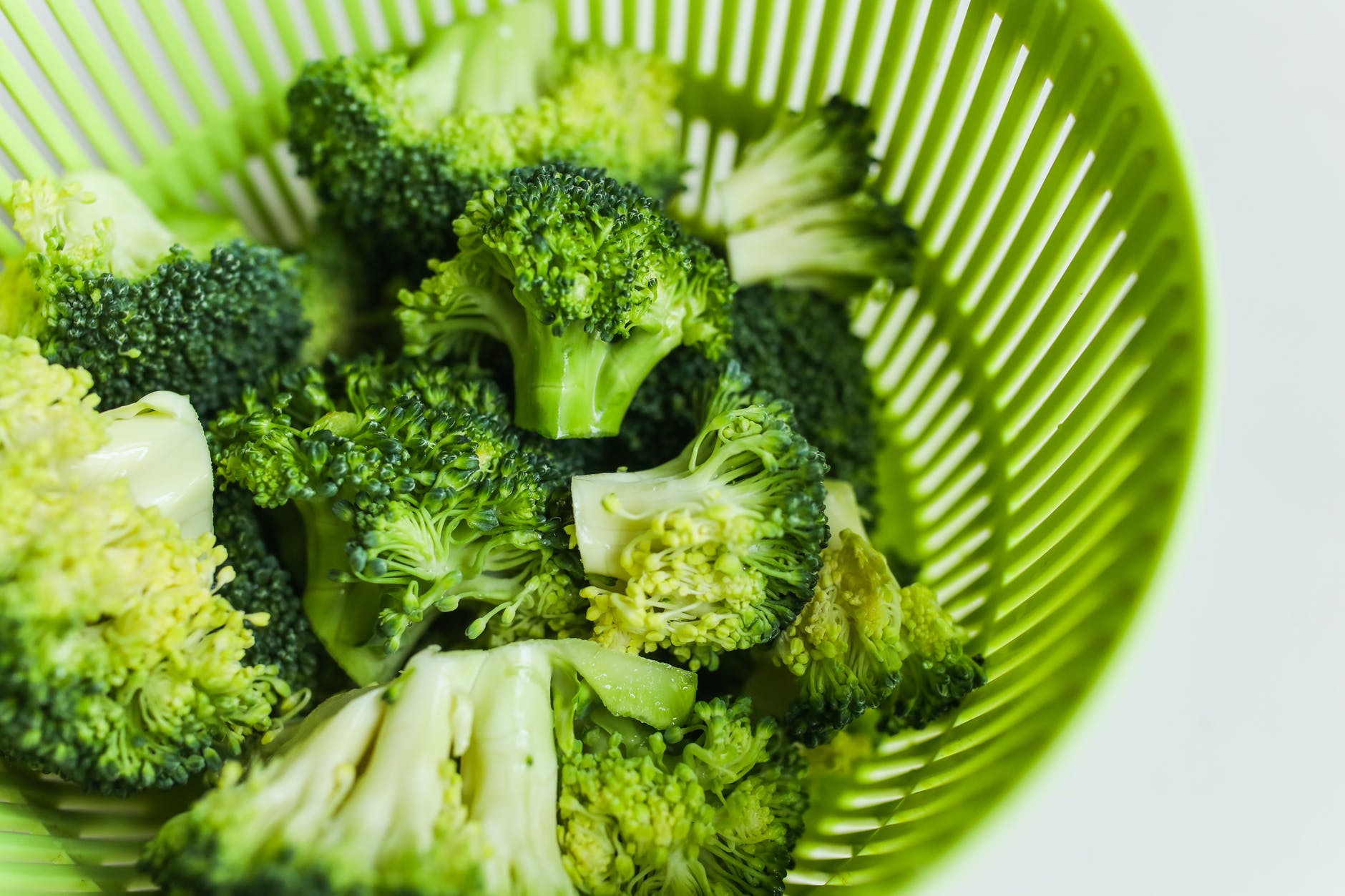 close up photo of broccoli on green tray