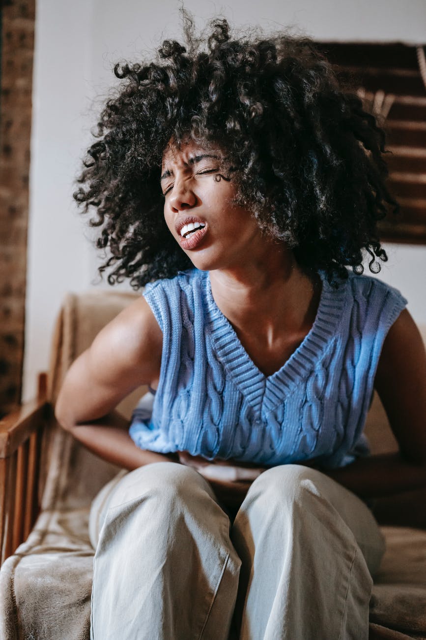 ethnic woman in agony at home