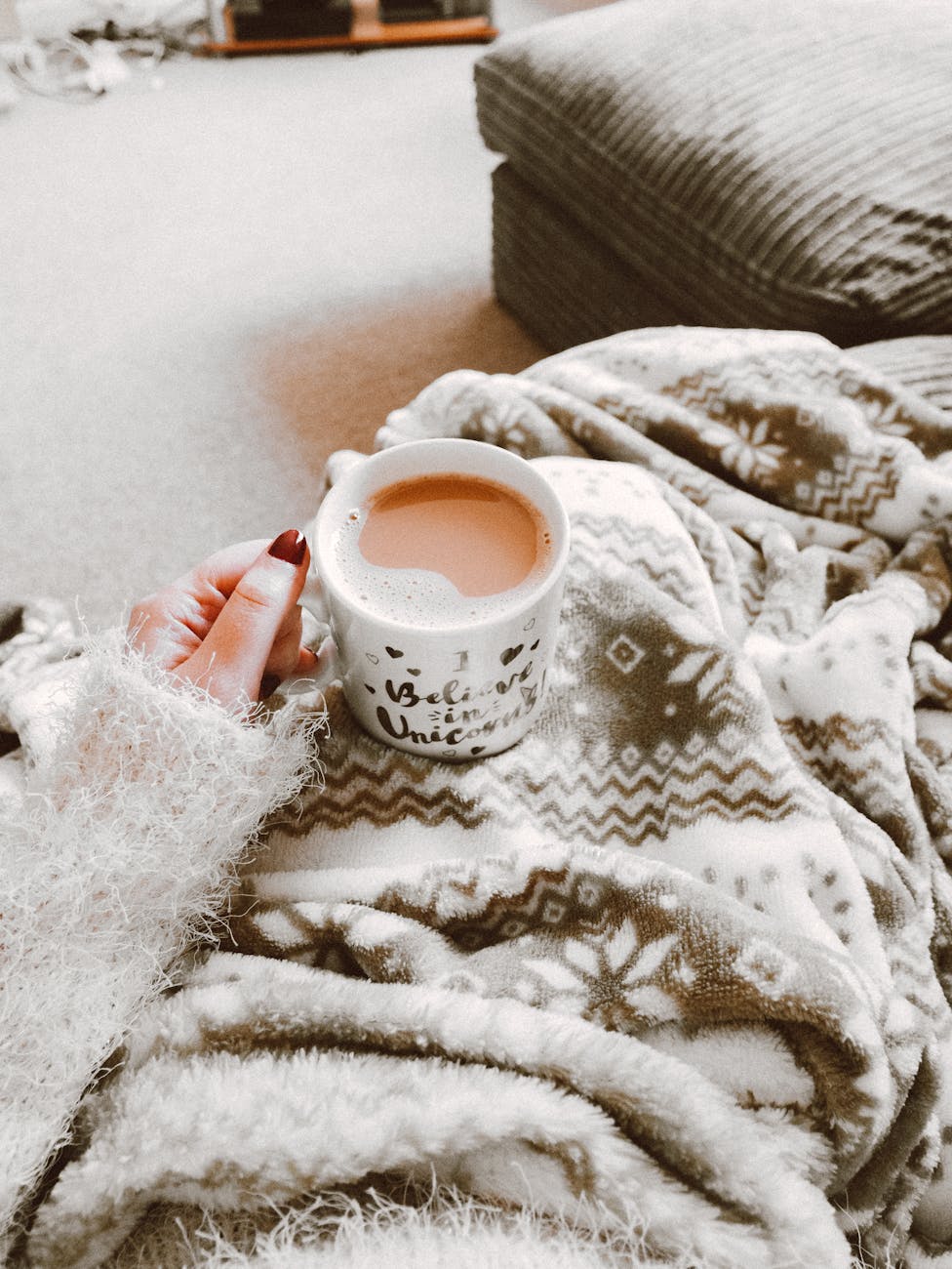 person holding coffee filled mug